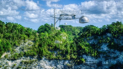 AX101_116.0000000F - Aerial stock photo of Top structure of the Arecibo Observatory and karst mountains in Puerto Rico