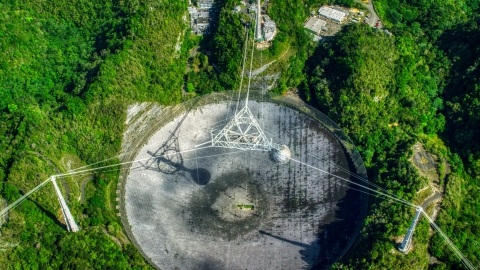 AX101_122.0000000F - Aerial stock photo of Looking down at the Arecibo Observatory dish in Puerto Rico 