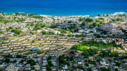 AX101_135.0000000F - Aerial stock photo of Houses and apartment buildings near the Caribbean island coast, Arecibo, Puerto Rico