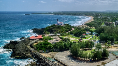 AX101_143.0000000F - Aerial stock photo of Arecibo Lighthouse on a small hill overlooking the Caribbean, Puerto Rico 