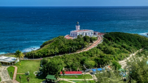 AX101_144.0000000F - Aerial stock photo of Arecibo Lighthouse with a view of the coastal waters of the Caribbean, Puerto Rico 