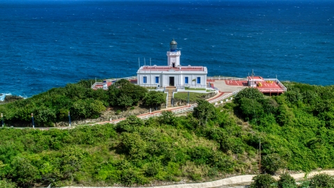 AX101_144.0000277F - Aerial stock photo of Arecibo Lighthouse beside the coastal waters of the Caribbean, Puerto Rico 