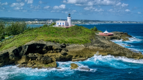 AX101_147.0000000F - Aerial stock photo of Arecibo Lighthouse on the Caribbean island coast, Puerto Rico 
