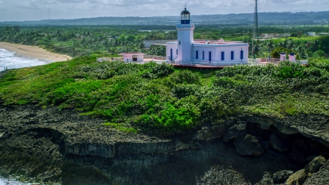 AX101_149.0000000F - Aerial stock photo of The hilltop Arecibo Lighthouse in Puerto Rico 