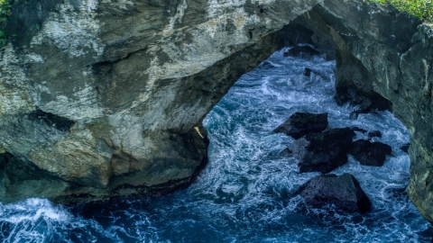 AX101_164.0000000F - Aerial stock photo of Water-filled sea cave on the coast, Arecibo, Puerto Rico 