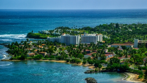AX101_217.0000000F - Aerial stock photo of Coastal hotel by pristine blue water, Dorado, Puerto Rico 