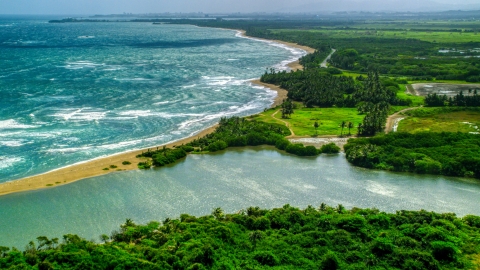 AX101_220.0000000F - Aerial stock photo of A desert Caribbean island beach and lagoon in Dorado, Puerto Rico 