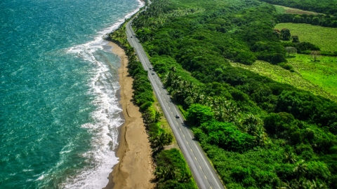 AX101_225.0000241F - Aerial stock photo of A Caribbean island beach and highway in Dorado, Puerto Rico