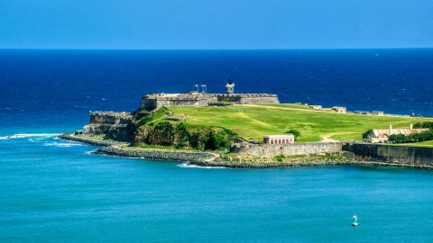 AX101_236.0000000F - Aerial stock photo of Back of the Fort San Felipe del Morro by crystal blue waters, Old San Juan, Puerto Rico