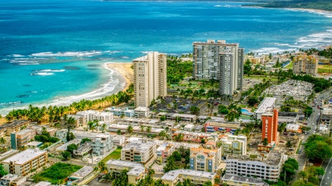 AX102_050.0000000F - Aerial stock photo of Beachfront condominium complexes in Luquillo, Puerto Rico 