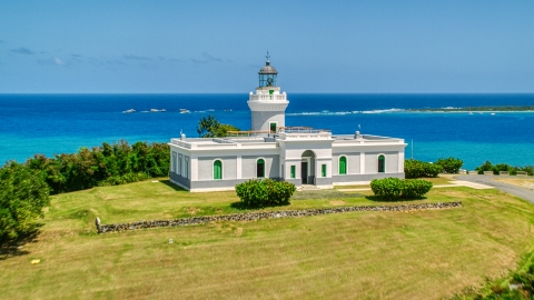 AX102_063.0000106F - Aerial stock photo of Cape San Juan Light with a view of crystal blue waters, Puerto Rico