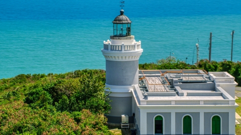 AX102_067.0000000F - Aerial stock photo of The Cape San Juan Light tower with ocean views, Puerto Rico