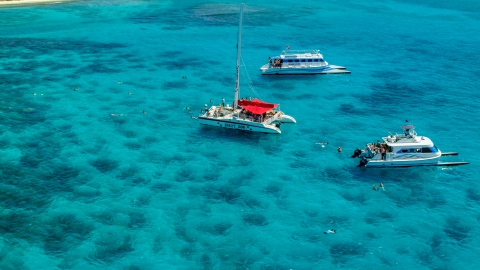 AX102_079.0000055F - Aerial stock photo of Three catamarans in clear blue water, Rada Fajardo, Puerto Rico 