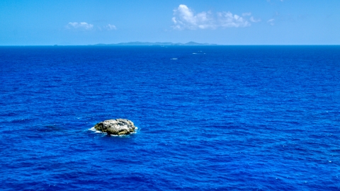 AX102_091.0000000F - Aerial stock photo of Tiny island in a deep blue ocean near Culebra, Puerto Rico 