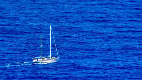 AX102_105.0000100F - Aerial stock photo of Sail boat in sapphire blue waters, Culebra, Puerto Rico 