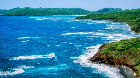 AX102_109.0000094F - Aerial stock photo of Sapphire blue waters by a green island coastline,  Culebra, Puerto Rico 