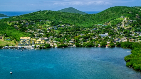 AX102_143.0000190F - Aerial stock photo of Coastal town with small factory beside blue waters, Culebra, Puerto Rico 