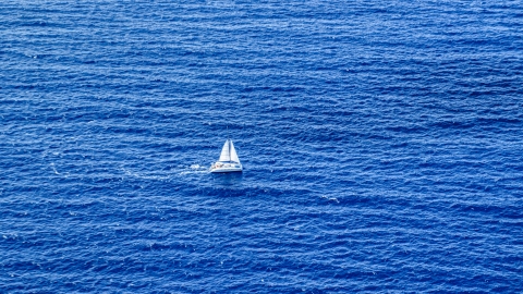 AX102_193.0000158F - Aerial stock photo of Catamaran sailing sapphire blue waters, Atlantic Ocean
