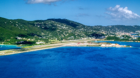 AX102_195.0000000F - Aerial stock photo of Cyril E King Airport and hillside homes on the coast, St. Thomas, US Virgin Islands