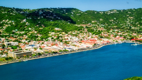 AX102_207.0000000F - Aerial stock photo of Caribbean town and hillsides by sapphire waters, Charlotte Amalie, St. Thomas