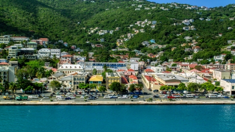 AX102_227.0000253F - Aerial stock photo of Island town buildings on the harbor shore in Charlotte Amalie, St Thomas 