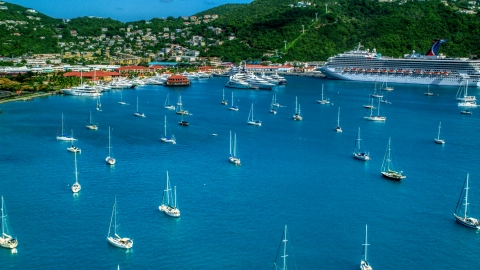 AX102_230.0000000F - Aerial stock photo of Sailboats and cruise ship in sapphire blue waters of the harbor in Charlotte Amalie, St Thomas