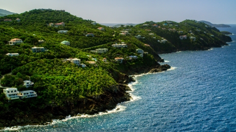 AX102_267.0000000F - Aerial stock photo of Hillside mansions on an island coast overlooking the ocean, Northside, St Thomas 