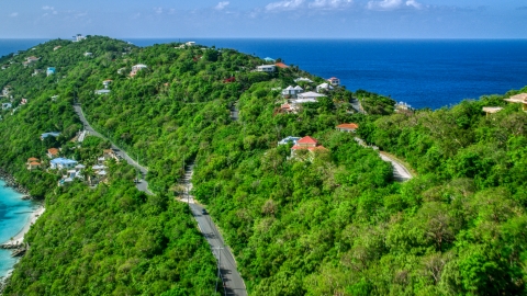 AX102_274.0000000F - Aerial stock photo of Oceanfront hillside homes with a view of turquoise Caribbean waters, Magens Bay, St Thomas 