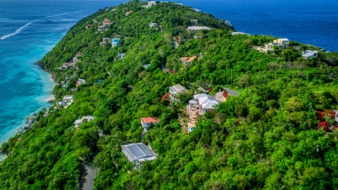 AX102_274.0000327F - Aerial stock photo of Oceanfront hillside island homes near Caribbean waters, Magens Bay, St Thomas 
