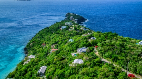 AX102_276.0000000F - Aerial stock photo of Upscale hilltop homes overlooking Caribbean waters, Magens Bay, St Thomas