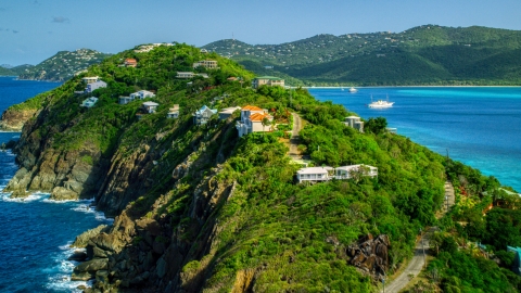AX102_281.0000033F - Aerial stock photo of Hillside oceanfront homes by sapphire blue Caribbean waters, Magens Bay, St Thomas 