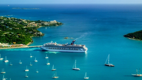 AX103_005.0000260F - Aerial stock photo of Cruise ship near sailboats in turquoise blue Caribbean waters, Charlotte Amalie, St Thomas