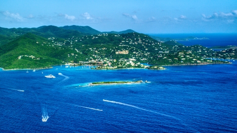 AX103_016.0000000F - Aerial stock photo of Coastal town on a hillside and blue Caribbean waters, Cruz Bay, St John