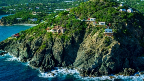 AX103_036.0000000F - Aerial stock photo of Cliff top mansions above sapphire blue Caribbean waters, Cruz Bay, St John