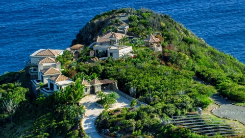 AX103_038.0000258F - Aerial stock photo of Hilltop mansion with a sapphire blue ocean view, Cruz Bay, St John