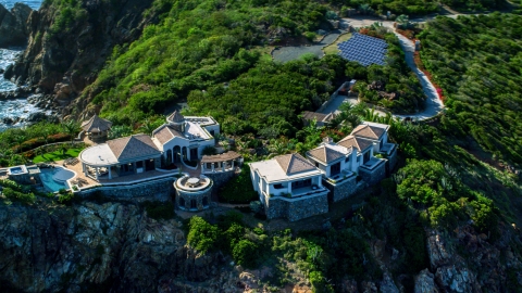 AX103_039.0000327F - Aerial stock photo of Hilltop mansion with a Caribbean blue ocean view, Cruz Bay, St John
