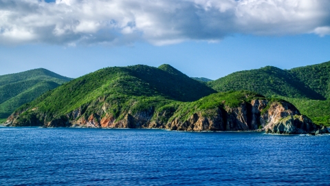 AX103_057.0000000F - Aerial stock photo of Coastal cliffs and jungle along sapphire blue Caribbean waters, Central, St John