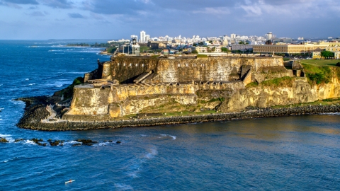 AX104_006.0000000F - Aerial stock photo of Historic Fort San Felipe del Morro, Old San Juan, sunset