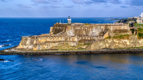 AX104_006.0000203F - Aerial stock photo of Iconic Fort San Felipe del Morro, Old San Juan, sunset