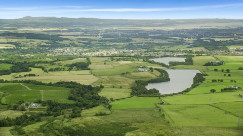 AX109_004.0000000F - Aerial stock photo of Green farm fields and a reservoir, Denny, Scotland