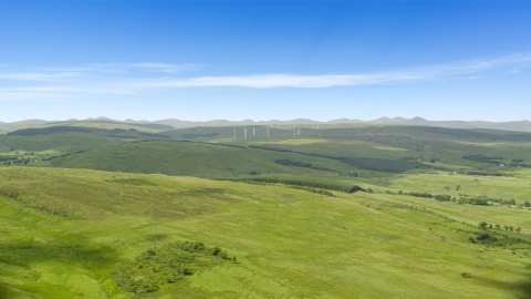 AX109_005.0000000F - Aerial stock photo of Hilltop windmills and farm fields in Denny, Scotland
