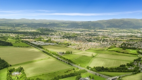 AX109_013.0000000F - Aerial stock photo of Farm fields near rural homes, Stirling, Scotland