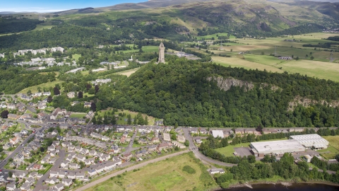 AX109_047.0000064F - Aerial stock photo of The historic Wallace Monument on a hill with trees, Stirling, Scotland