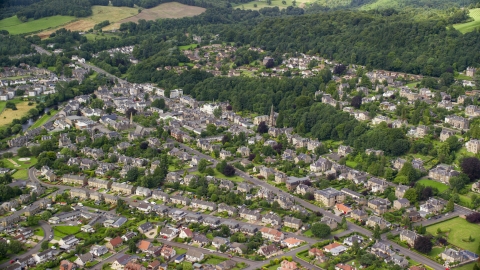 AX109_056.0000000F - Aerial stock photo of A residential neighborhood with trees in Stirling, Scotland