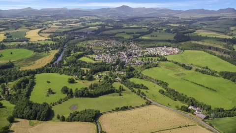 AX109_065.0000000F - Aerial stock photo of A rural village beside green farmland, Duone, Scotland