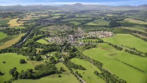 AX109_065.0000194F - Aerial stock photo of A rural village and green farmland, Duane, Scotland