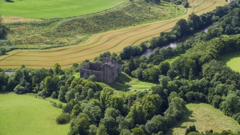 AX109_066.0000000F - Aerial stock photo of Historic Doune Castle and trees in Scotland