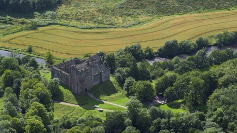 AX109_067.0000000F - Aerial stock photo of A view of Doune Castle with trees, Scotland