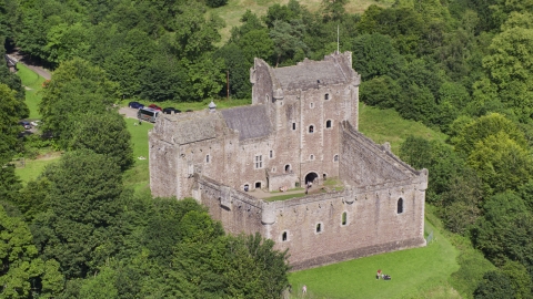 AX109_071.0000116F - Aerial stock photo of Historic Doune Castle with tourists on the grounds, Scotland