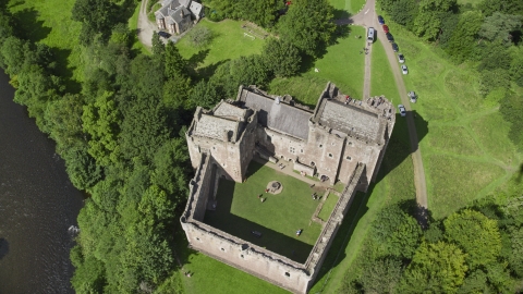 AX109_072.0000120F - Aerial stock photo of A bird's eye view of historic Doune Castle and its grounds, Scotland